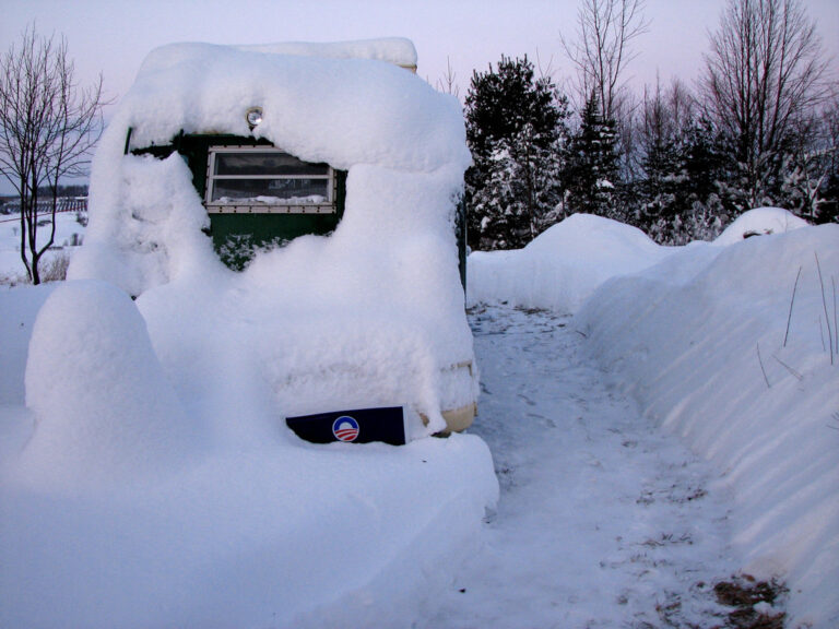 Snow Covered RV in trailer storage lot