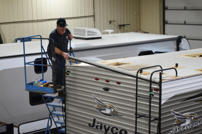 RV Technician fixing trailer roof