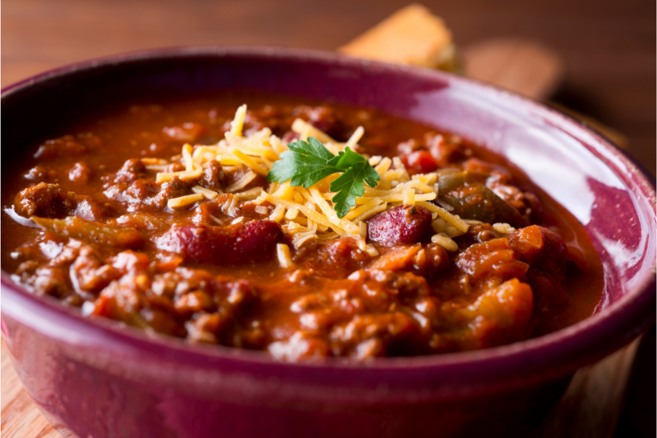 Campfire chili in a bright red bowl. 