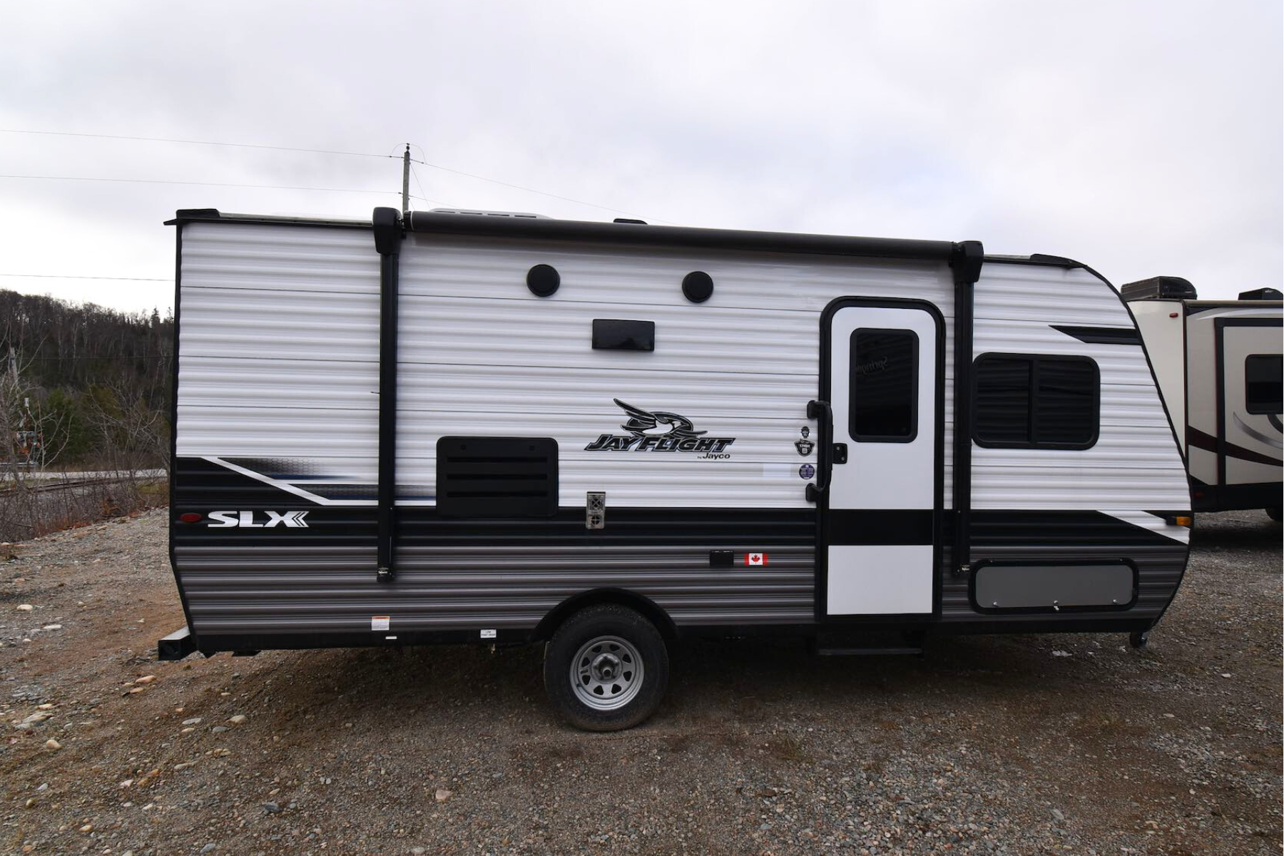 A Jayco Jay Flight SLX 174BH travel trailer parked on an RV dealership lot